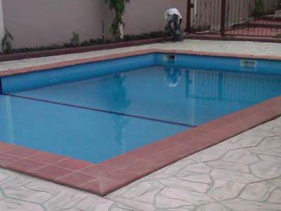 SWIMMING POOL WITH INCRETE PAVING BY POOLSIDE